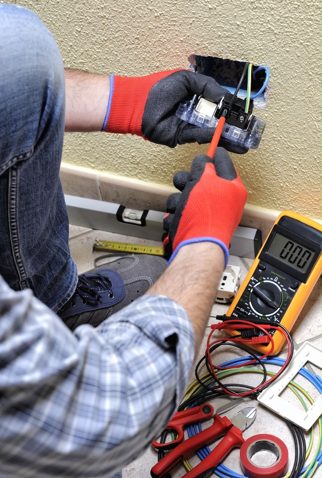 Electrical technician testing a circuit with a digital multimeter