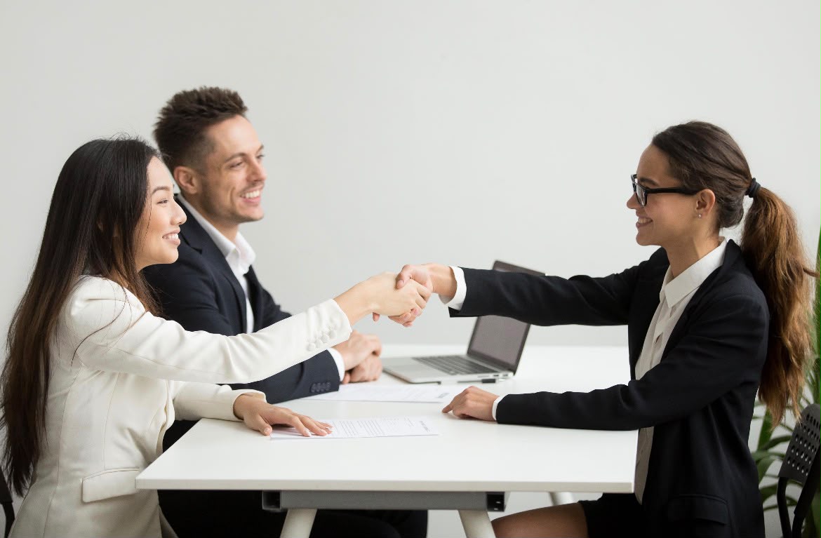 Employer welcoming a placed construction professional with a handshake